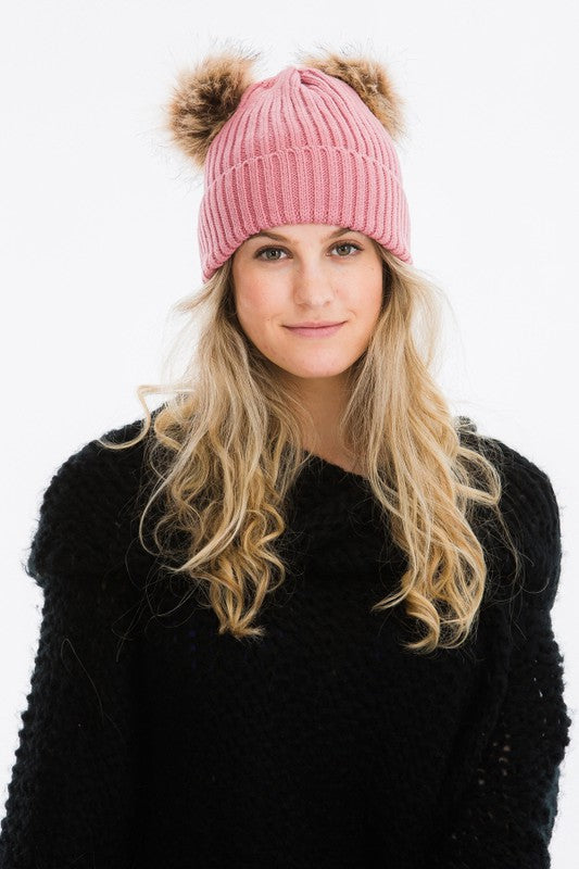 blush pink winter hat with 2 pom poms attached